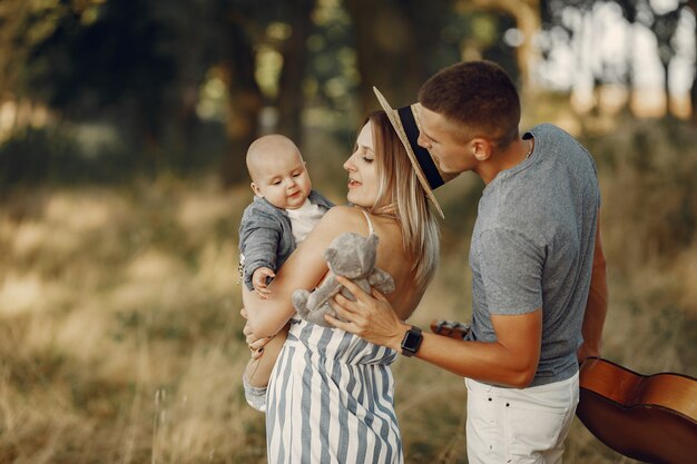 Famiglia sveglia che gioca in un campo di autunno