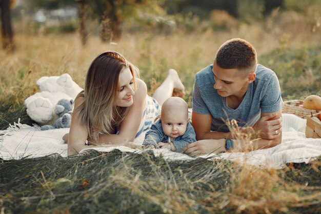 Famiglia sveglia che gioca in un campo di autunno