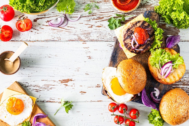 Fare hamburger fatti in casa. Ingredienti per cucinare su un tavolo di legno. Vista dall'alto o distesi. Copia spazio