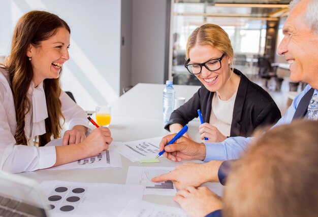 Felice businesspeople discutendo un piano finanziario nella riunione