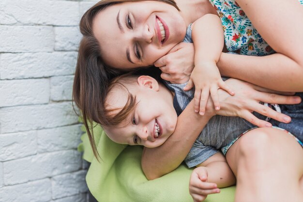 Felice giovane donna che gioca con il figlio