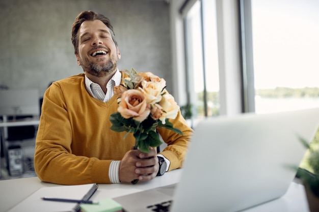 Felice uomo d'affari innamorato incontri online mentre lavora in ufficio