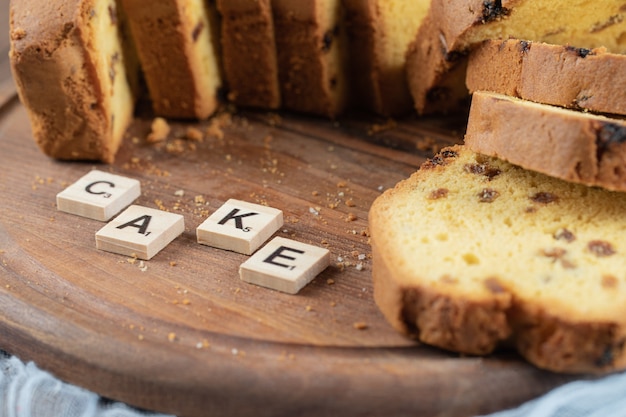 Fette di torta dolce isolate su una tavola di legno.