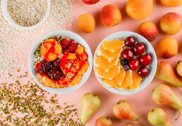 Fiocchi di avena con noci, ciliegia, arancia, frutti di bosco, pera, albicocca in ciotole