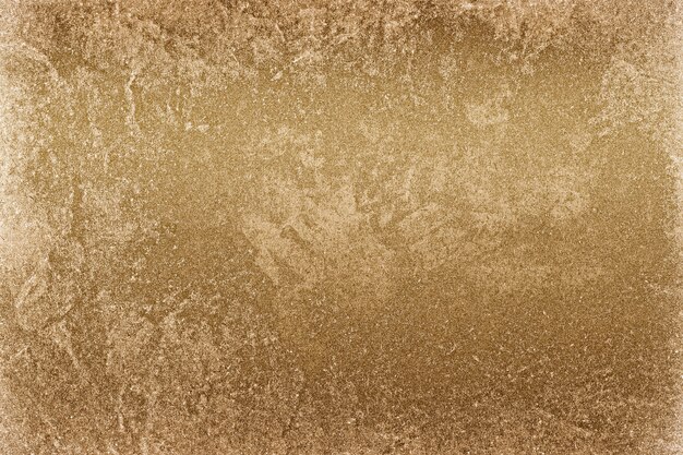 Fondo della superficie del muro di cemento dipinto all'incirca in oro