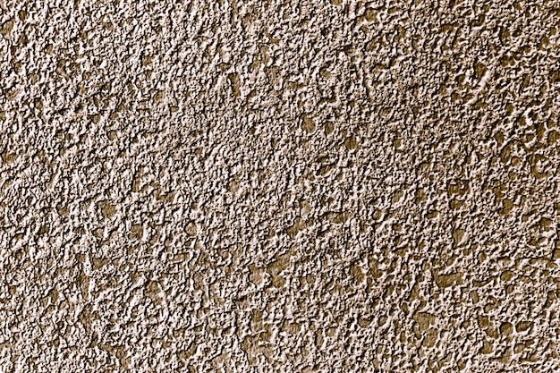 Fondo della superficie del muro di cemento dipinto all'incirca in oro