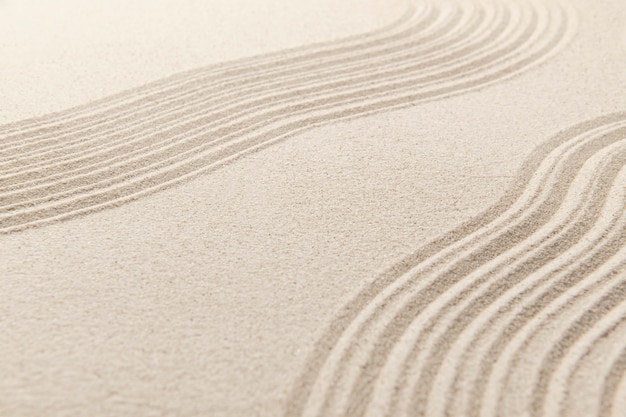 Fondo di struttura della superficie della sabbia zen e concetto di pace