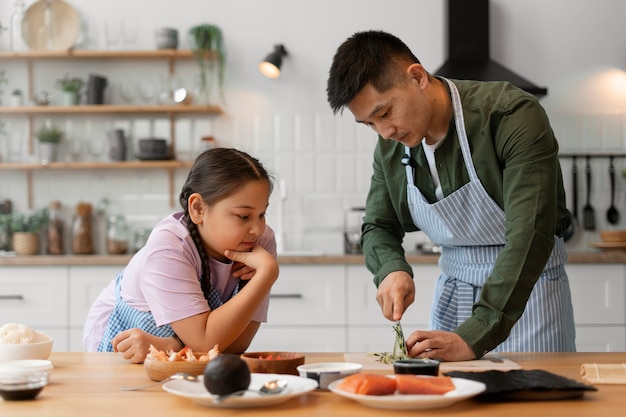 Genitore che insegna al figlio a fare il sushi