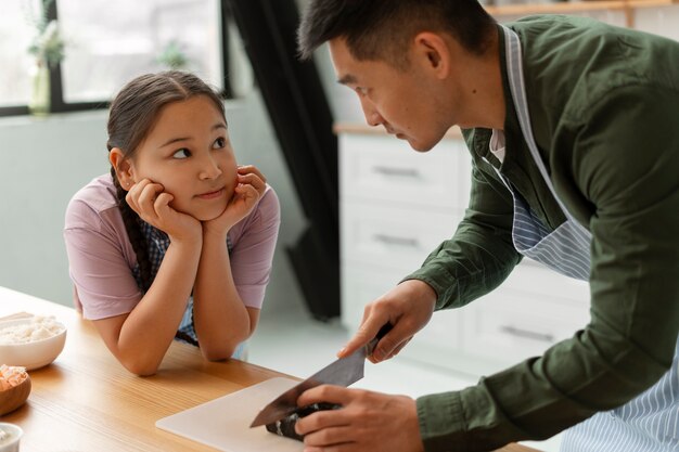 Genitore che insegna al figlio a fare il sushi