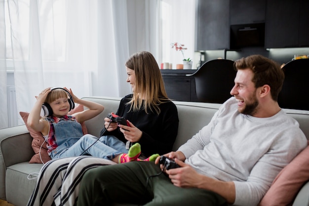 Genitori che ridono con i controllori guardando la figlia