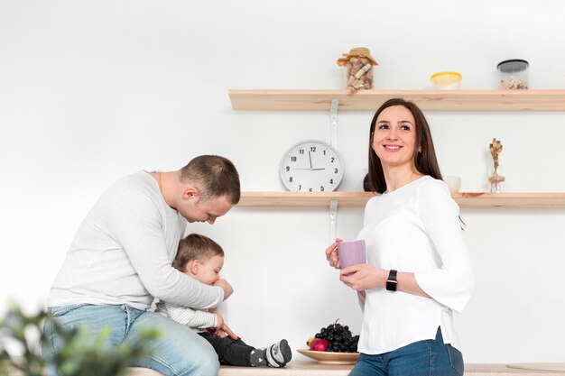 Genitori felici con bambino in cucina