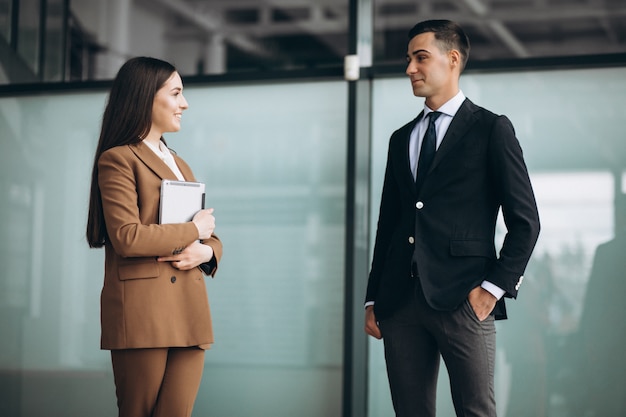 Gente di affari maschio e femminile che lavora alla compressa in ufficio