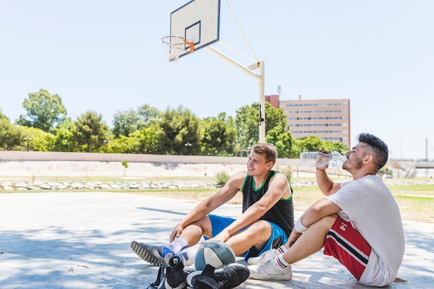 Giocatore di pallacanestro due che si distende alla corte esterna