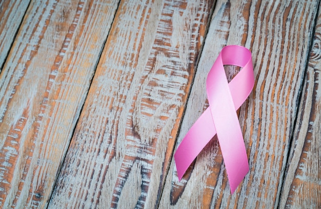 Giornata mondiale del cancro: Nastro Rosa su legno Backgr