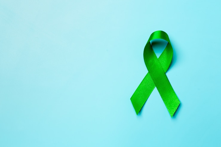 Foto gratuito giornata mondiale della salute mentale. nastro verde su sfondo blu