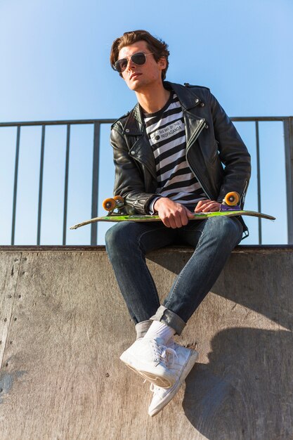 Giovane con il suo skateboard allo skate park