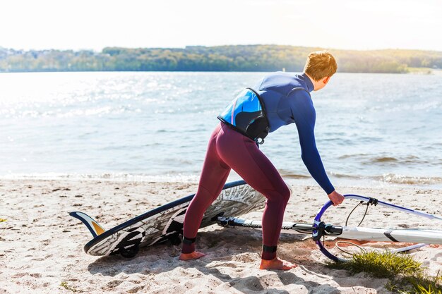 Giovane con tavola da kitesurf