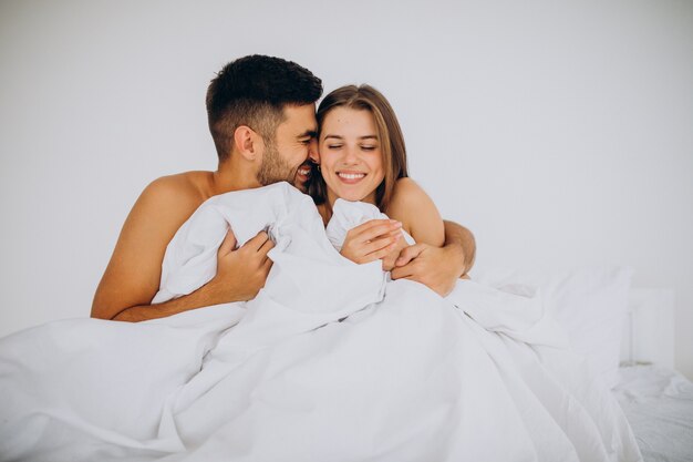 Giovane coppia insieme sdraiata a letto