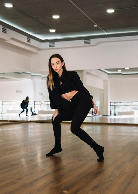 Giovane danzatore femminile che pratica nello studio di ballo