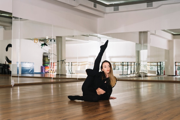 Giovane danzatore femminile che pratica nello studio di ballo