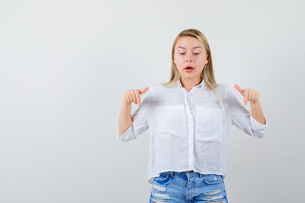 Giovane donna bionda in camicia bianca