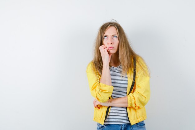 Giovane donna bionda in una giacca gialla