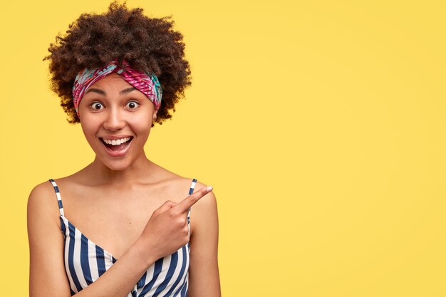 Giovane donna castana con capelli ricci e bandana colorata