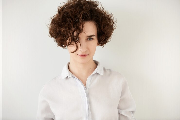 Foto gratuito giovane donna castana con capelli ricci