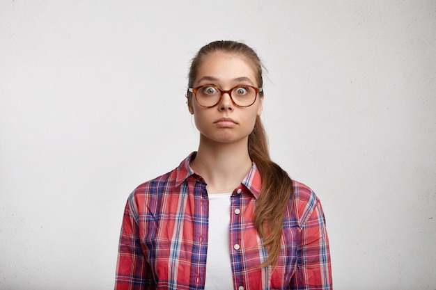 Giovane donna che indossa camicia a righe e occhiali da vista