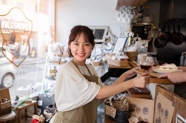 Giovane donna che sistema la sua pasticceria