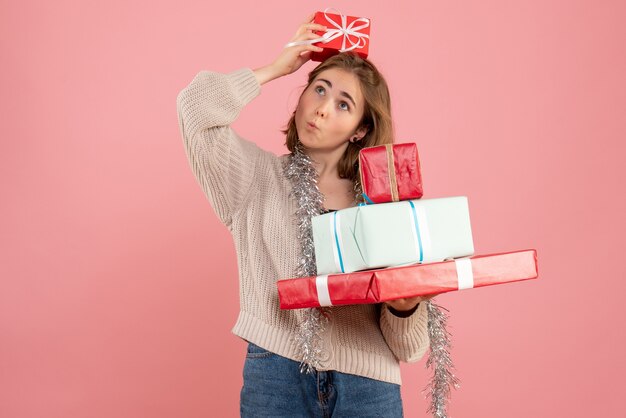 giovane donna che trasportano regali di Natale in rosa