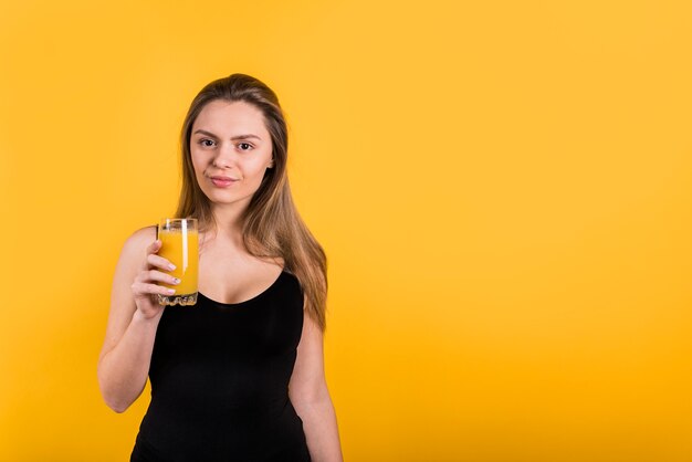Giovane donna con un bicchiere di succo
