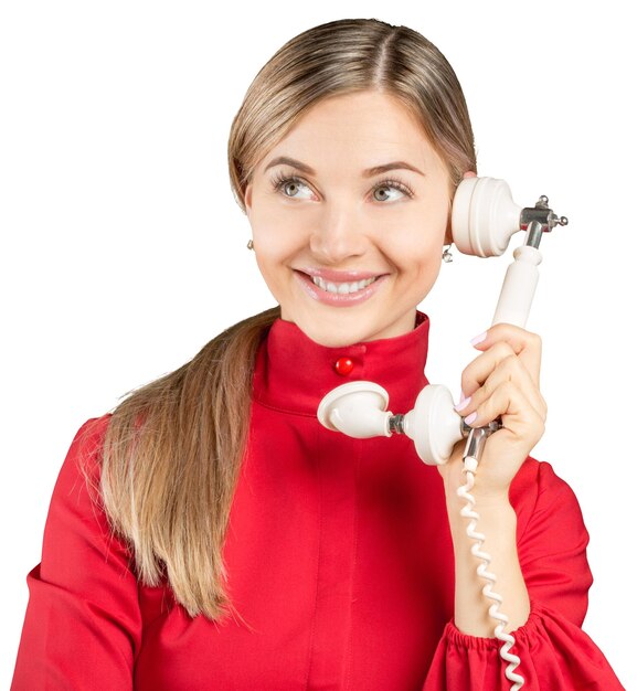 Giovane donna con un telefono vecchio stile