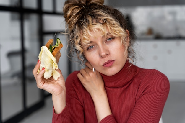 Giovane donna con uno stile di capelli panino disordinato