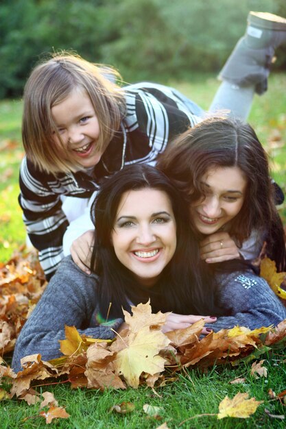 Giovane famiglia che fa passeggiata sana attraverso il parco di autunno