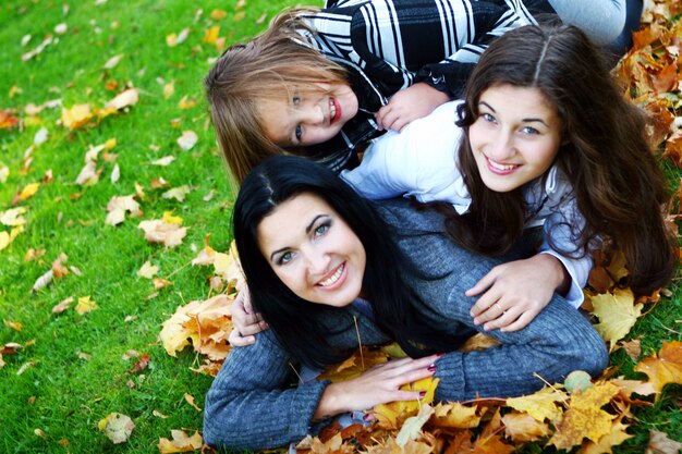 Giovane famiglia che fa passeggiata sana attraverso il parco di autunno