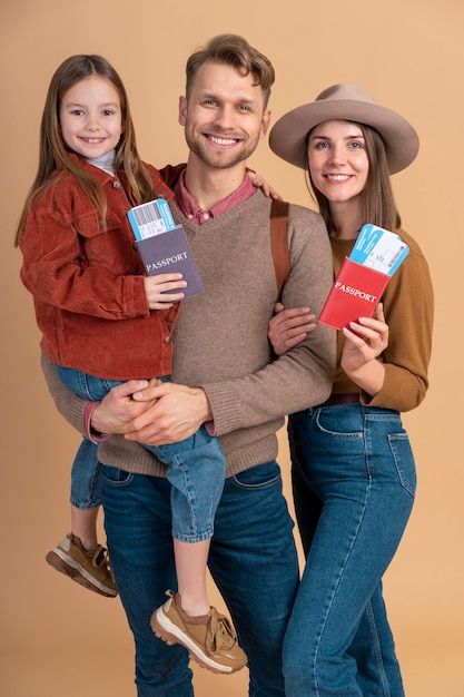 Giovane famiglia di tre persone che posano insieme prima delle vacanze di viaggio