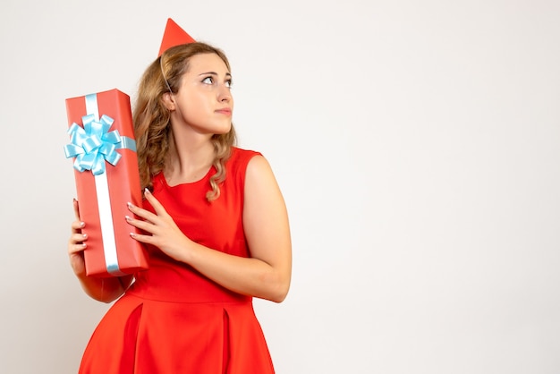 Giovane femmina di vista frontale in vestito rosso che celebra il natale con il presente