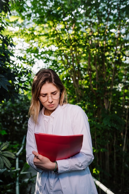 Giovane ingegnere agricolo femminile che lavora nella serra