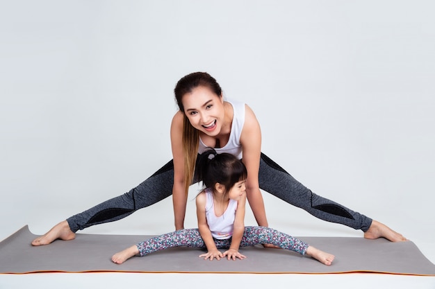 Giovane madre che prepara figlia adorabile con relativo alla ginnastica