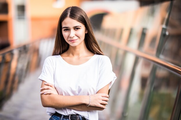 Giovane ragazza graziosa che sta sul ponte all'aperto