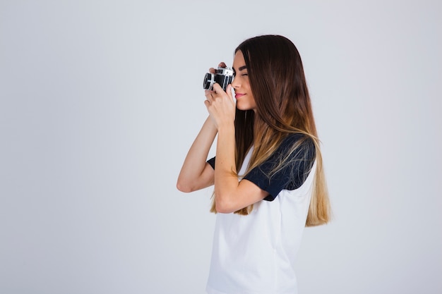 Giovane ragazza in posa con la fotocamera