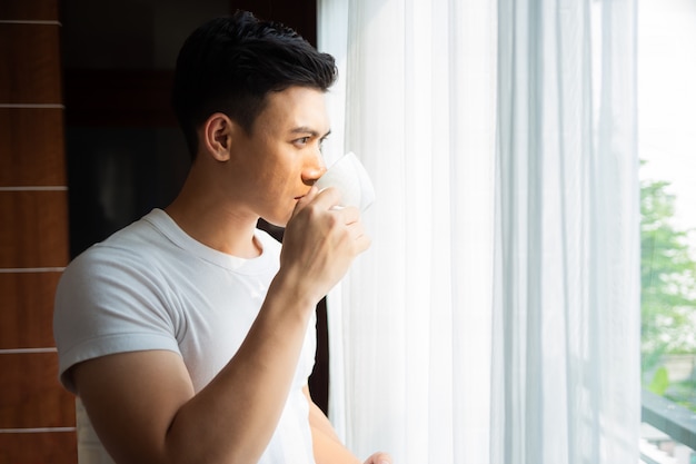 giovane uomo bere il caffè a casa