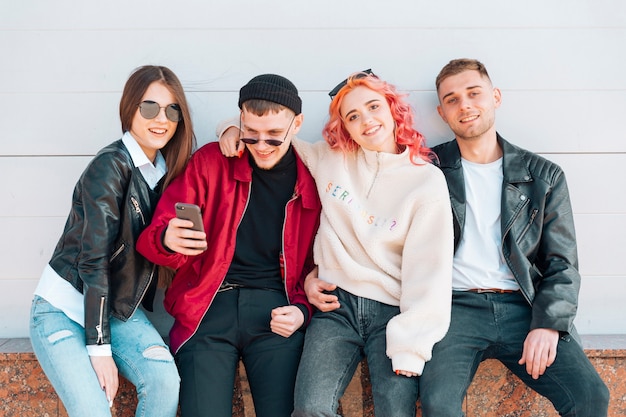 Giovani amici in posa durante l&#39;assunzione di selfie