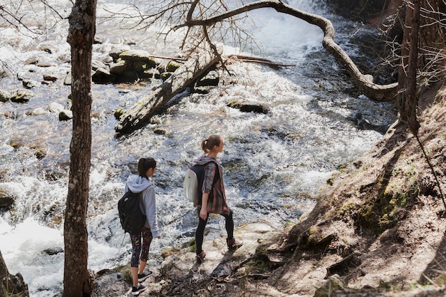 Giovani ragazze che camminano sulle pietre di fiume