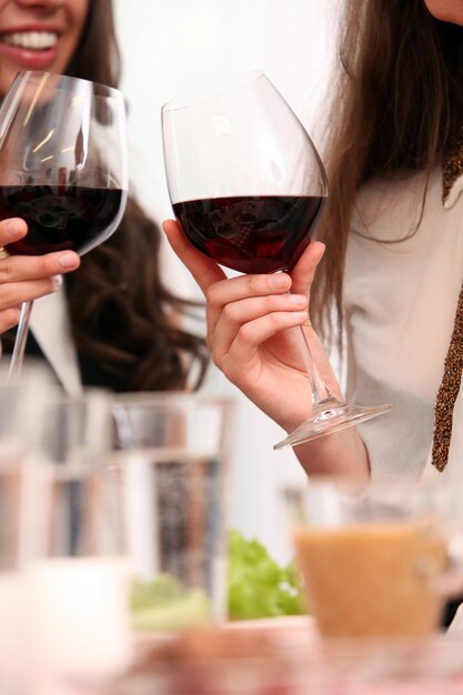 Gruppo di belle ragazze che godono del vino rosso