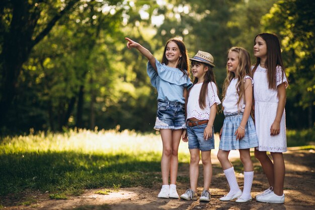 Gruppo di ragazze di anni dell'adolescenza divertendosi nella foresta