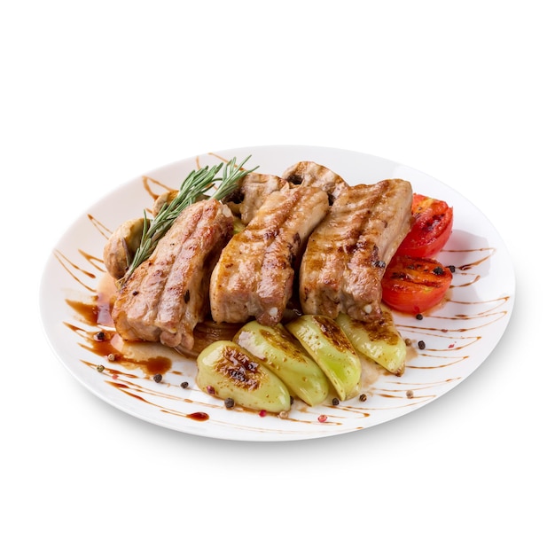 Gustose costolette alla griglia con verdure su piastra, isolate su sfondo bianco. Foto per il menu