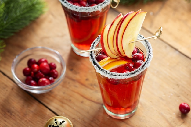 Gustoso cocktail natalizio fresco con mirtilli rossi servito in bicchieri. Avvicinamento