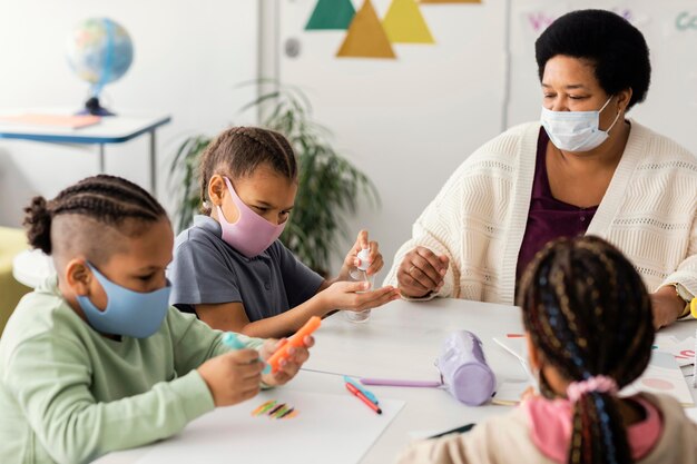 I bambini si disinfettano le mani in classe